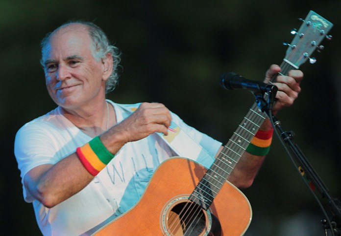 In this June 30, 2010, file photo, Jimmy Buffett performs at his sister’s restaurant in Gulf Shores, Ala. The Jimmy Buffett musical making its world premiere in 2017 in California has a new name and a Tony Award-winning creative support team. The musical is now titled “Escape to Margaritaville.” (AP Photo/Dave Martin)