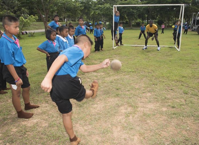 Sattahip (June 22, 2016) Operations Specialist 1st Class Charlon Clarke plays soccer with children from Chuksamet School during a community service event in support of CARAT Thailand 2016. (U.S. Navy photo by Mass Communication Specialist 2nd Class Joshua Fulton/Released)