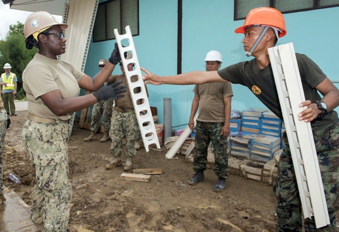 Sattahip (June 21, 2016) Construction builder Kiara Harris from Naval Mobile Construction Battalion (NMCB) 4 works with a Royal Thai Navy Seabee to construct a library at Khao Chi Chan School CARAT 2016. (U.S. Navy photo by Mass Communication Specialist 2nd Class Joshua Fulton/Released)