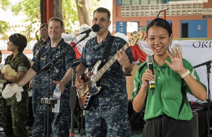 Pattaya (June 21, 2016) The U.S. Navy 7th Fleet Rock Band “Orient Express” invites a student from the Photisampan School to sing a local song during a joint rock concert with the Royal Thai Marine Corps Band. (U.S. Navy photo by Mass Communication Specialist 2nd Class Joshua Fulton)