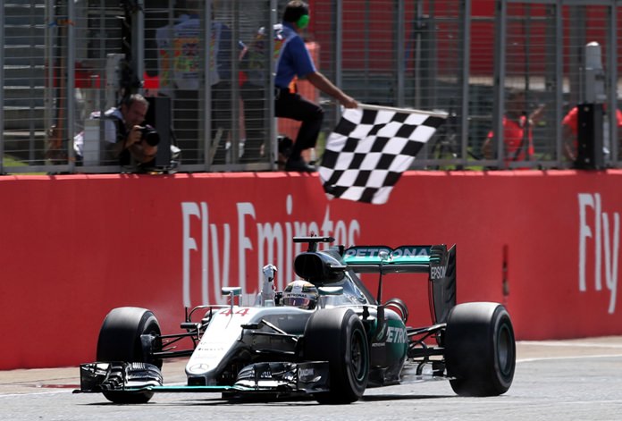 Mercedes driver Lewis Hamilton of Britain crosses the finish line to win the British Formula One Grand Prix at the Silverstone racetrack, Silverstone, England, Sunday, July 10. (David Davies/PA via AP)