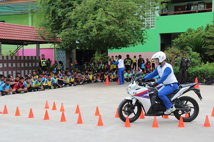 A member of staff demonstrates how to drive through cone obstacles.
