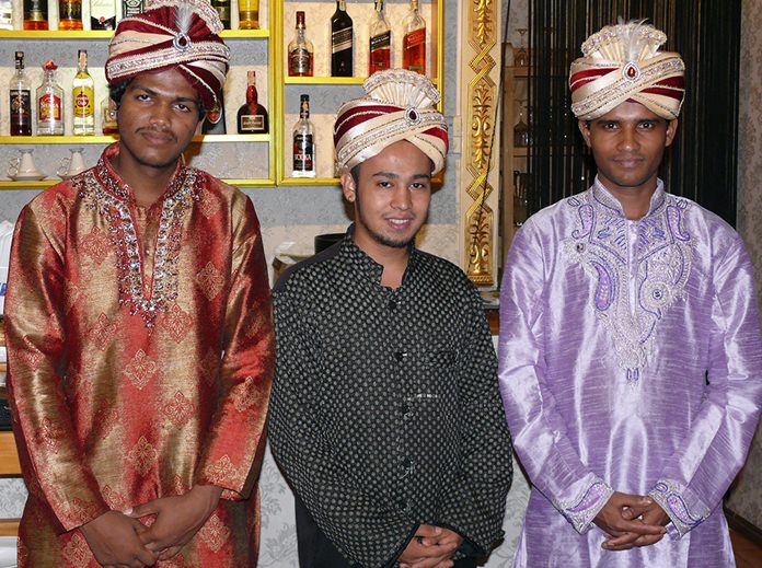 Indian waiters dressed in Indian style.