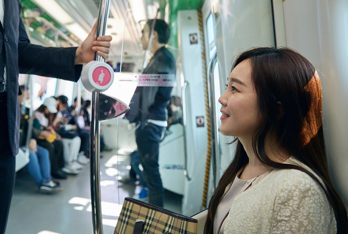 In this Wednesday, April 6, 2016 photo provided by Busan Metropolitan City, a woman sits on special priority seats next to a metal bar attached with a “pink light” wireless sensor in a subway train in Busan, South Korea. South Korea’s second-largest city of Busan is testing a wireless technology it hopes can alleviate such problems and perhaps help address one of the biggest challenges facing the Asian country: a stubbornly low birthrate. (Kwon Sung-hoon/Busan Metropolitan City via AP)