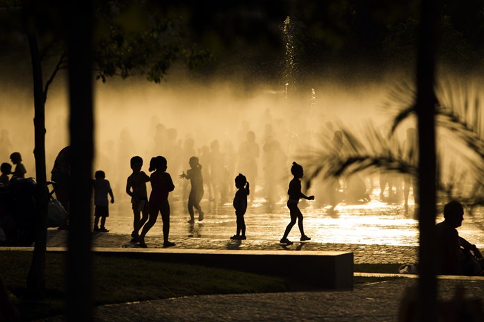 In this June 29, 2015, file photo, children play as they cool down in a fountain beside the Manzanares River in Madrid, Spain. Earth’s fever got worse last year, breaking dozens of climate records, 450 international scientists diagnosed in a massive report nicknamed the annual physical for the planet. (AP Photo/Andres Kudacki, File)