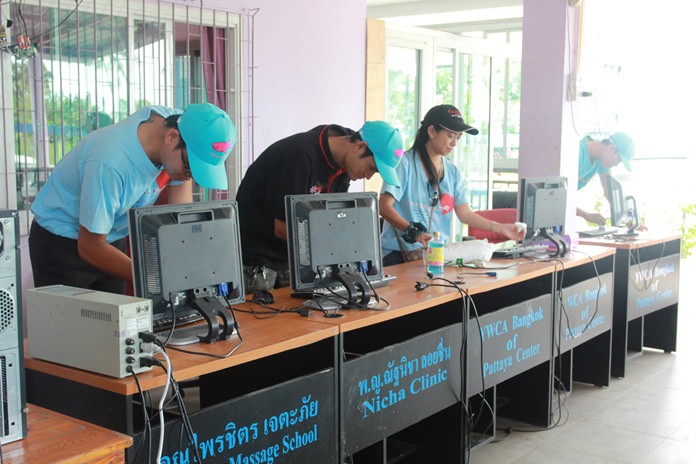 Sunee Robinson (right) Manager of Public Relations and her team clean computers and peripherals.   