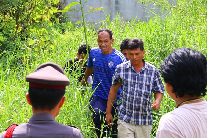 Somchai Boonyung (front, center) admitted to using a scythe to slash to death his rude, drug filled nephew.