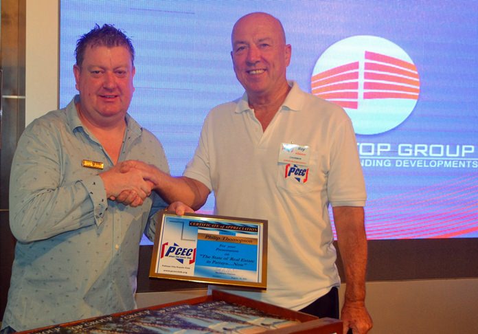 MC Roy Albiston presents the PCEC’s Certificate of Appreciation to Philip Thompson for his talk about the condo real estate market in Pattaya.