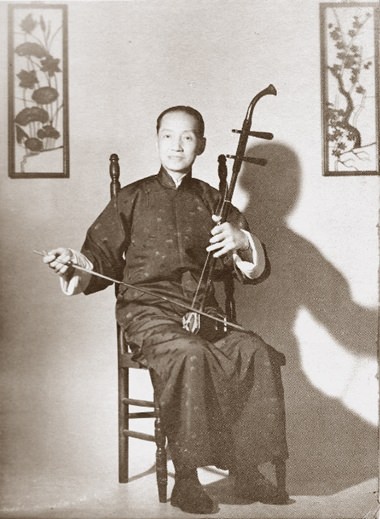 Composer Lü Wencheng playing the two-stringed erhu.