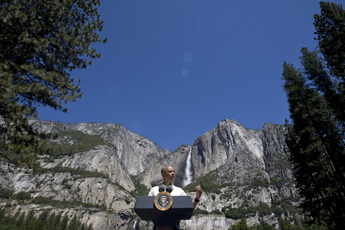 In this Saturday, June 18, 2016, file photo, President Barack Obama speaks by the Sentinel Bridge in the Yosemite Valley in front of Yosemite Falls, the highest waterfall in the park, at Yosemite National Park, Calif. (AP Photo/Jacquelyn Martin, File)