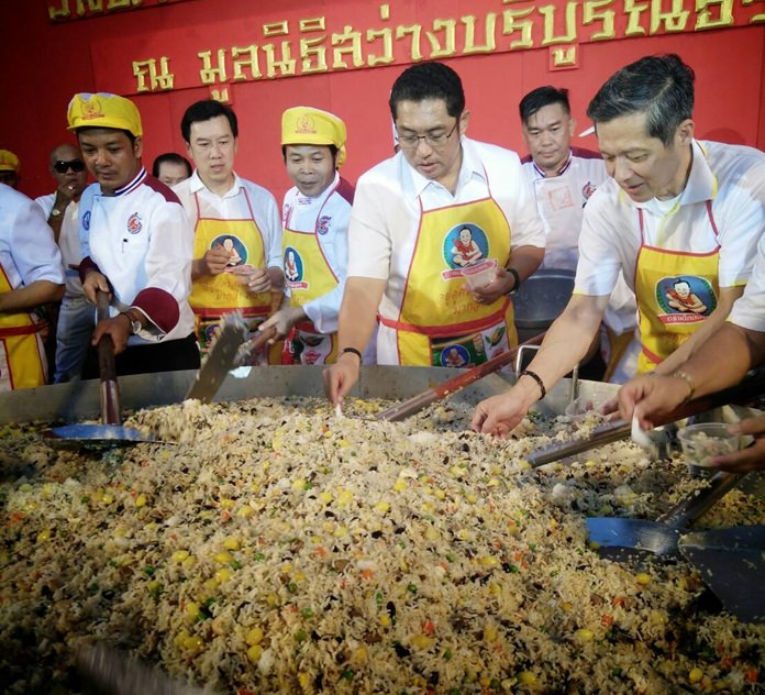 Local dignitaries stir up this year’s “magic rice” dish for the masses.