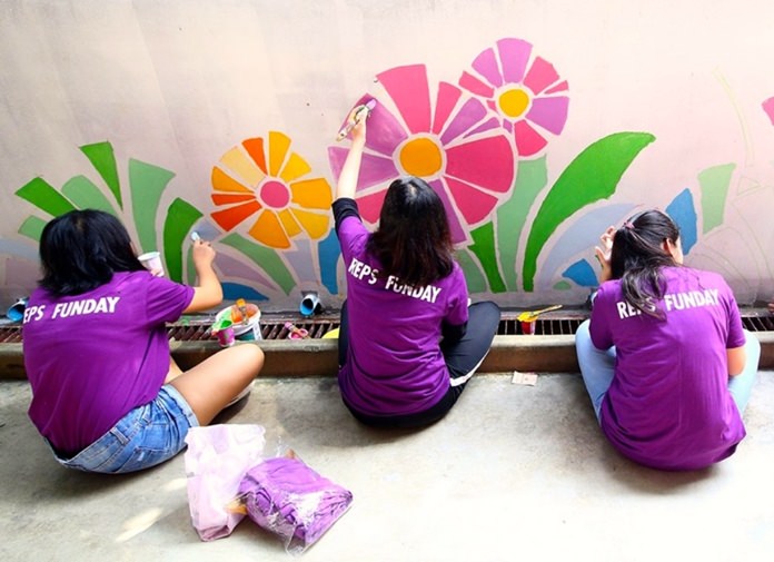 Painting the school wall is fun.