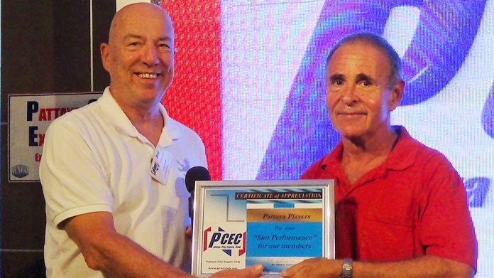 Sheldon Penner, on behalf of the Pattaya Players, accepts the PCEC’s Certificate of Appreciation from MC Roy Albiston.