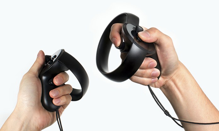 Oculus hopes people find their Oculus Touch hand-held controllers more comfortable and intuitive to use than traditional video game controllers. Users can make gestures and grasp virtual objects within the simulated worlds projected by Oculus Rift headsets. (Oculus via AP)