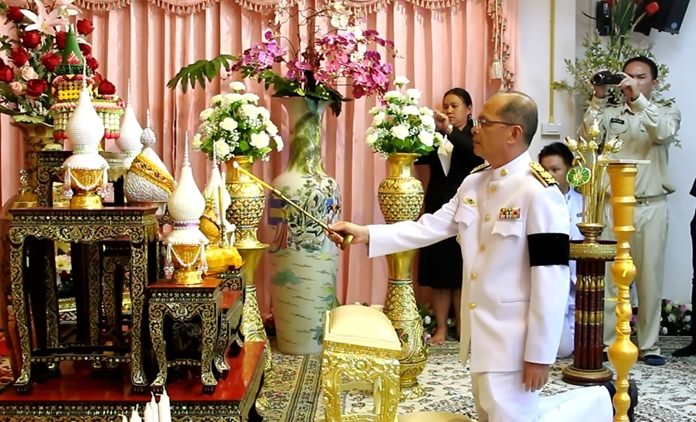 Banglamung District Deputy Chief Adirek Maimongkol lights incense and candles at Nongprue Temple.