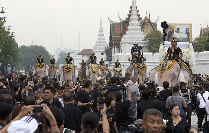 Mahouts lead a procession of 11 white elephants past the Grand Palace in honor of HM the late King Bhumibol Adulyadej. (AP Photo/Mark Baker, File)