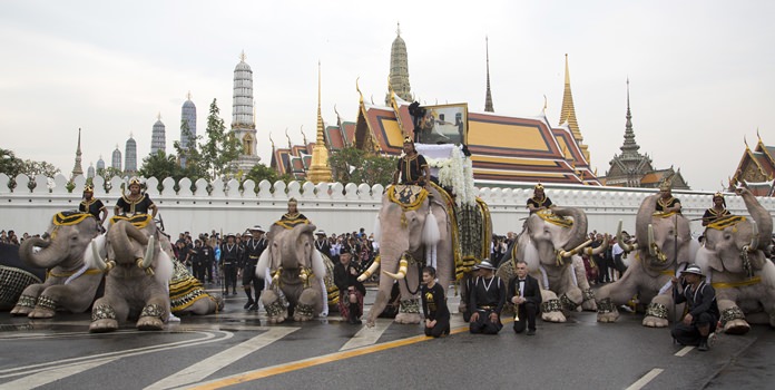 Mahouts lead white elephants to kneel in front of the Grand Palace. (AP Photo/Mark Baker)