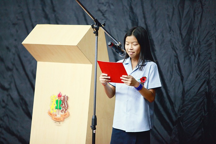 A Primary student reads a poem at the service.