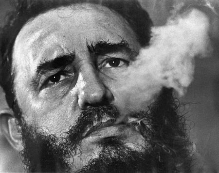In this March 1985 file photo, Cuba’s leader Fidel Castro exhales cigar smoke during an interview at the presidential palace in Havana, Cuba. (AP Photo/Charles Tasnadi, File)