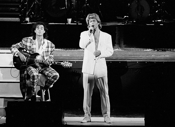 In this April 7, 1985 file photo, George Michael and Andrew Ridgeley of the British group WHAM! perform during a concert in Peking (Beijing), China. (AP Photo)