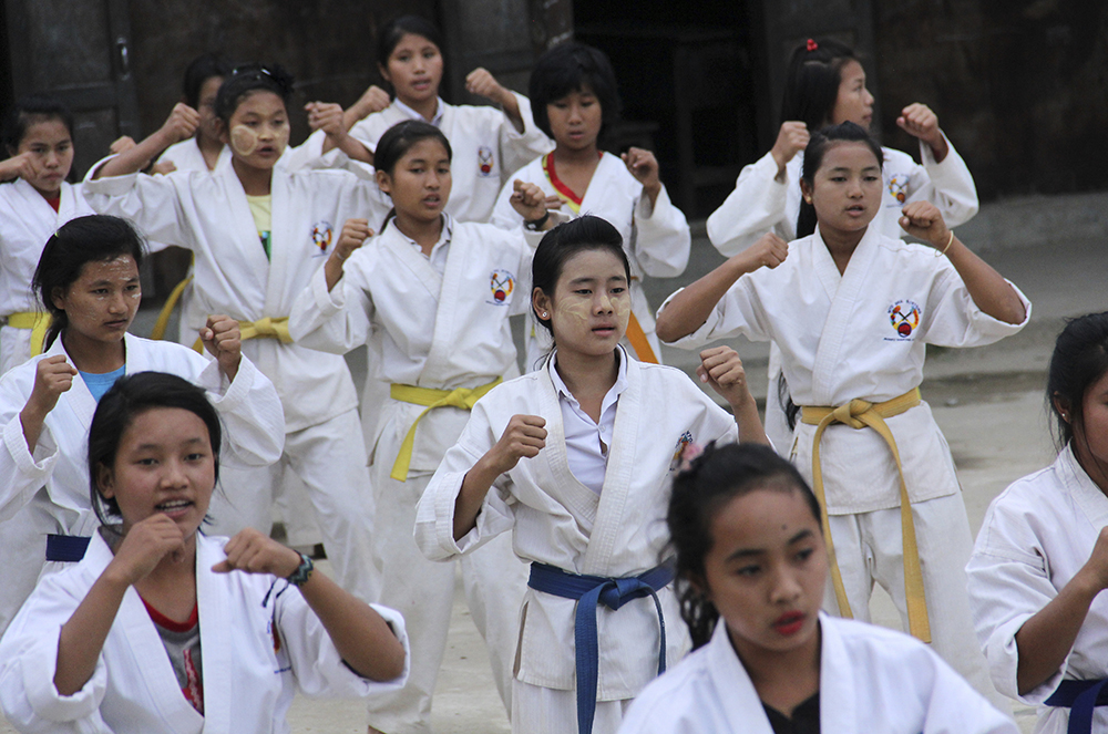 This Nov. 29, 2016 file photo shows internally displaced girls in Jeyang village camp, near the China border, joining the karate training for self-defense class in Kachin state, Myanmar. (AP Photo/Esther Htusan)