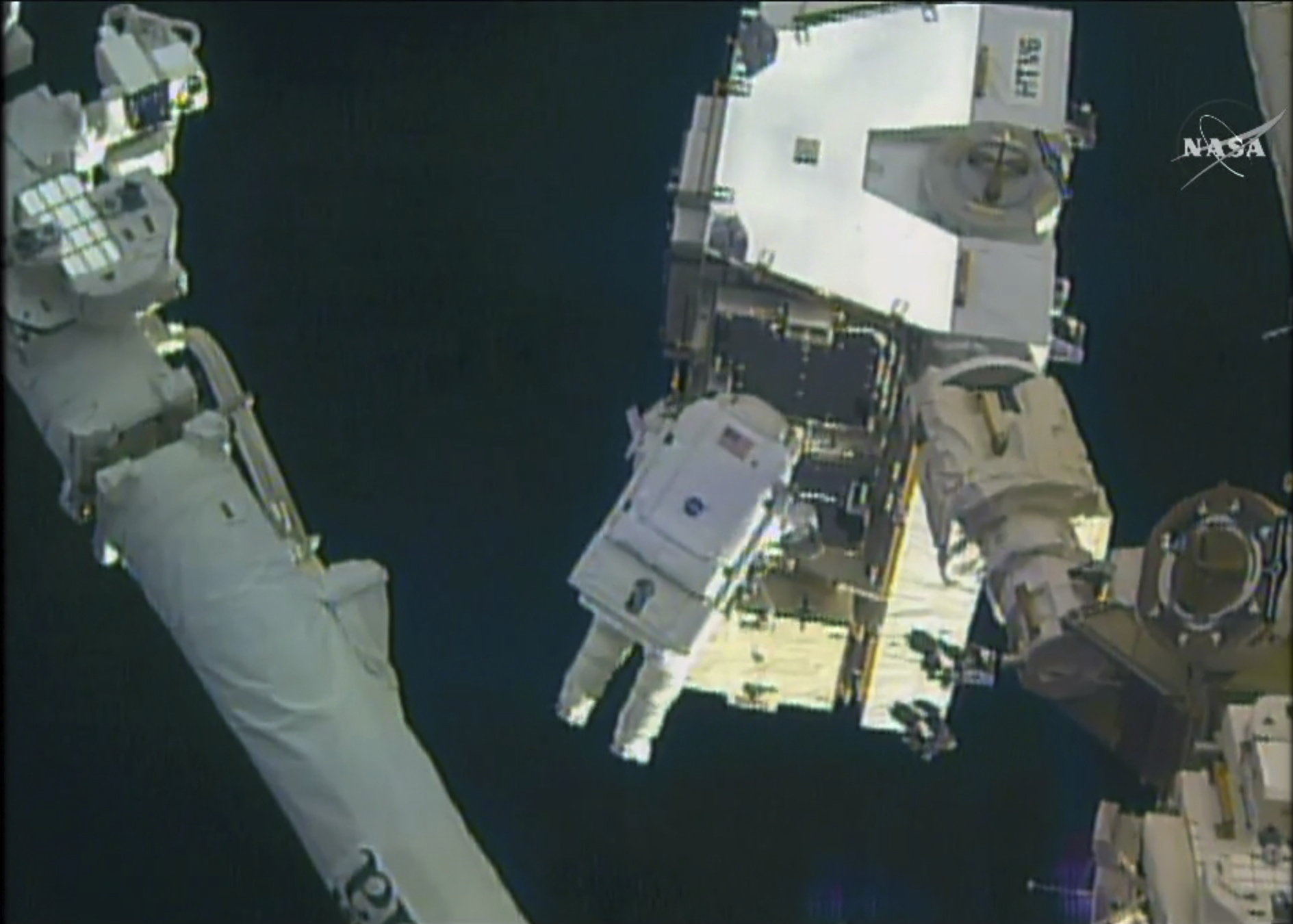 In this still image taken from video provided by NASA, astronaut Peggy Whitson takes a spacewalk outside the International Space Station on Friday, Jan. 6, 2016. Whitson and Commander Shane Kimbrough went spacewalking to hook up fancy new batteries on the International Space Station's sprawling power grid. (NASA via AP)