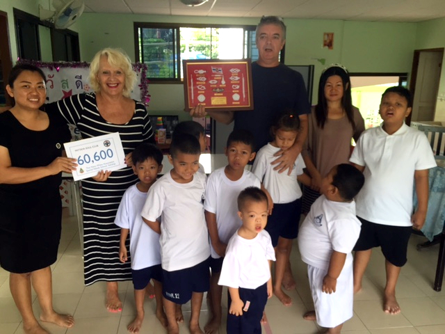 Eva Johnson (2nd left), co-founder of Pattaya Soul Club, hands a cheque for THB 60,600 to senior teacher Tak (far left) at the Sattahip School for Special Needs Children. Also pictured is Ivan Longland (centre-right, rear), a guest DJ at the popular Souled Out events.