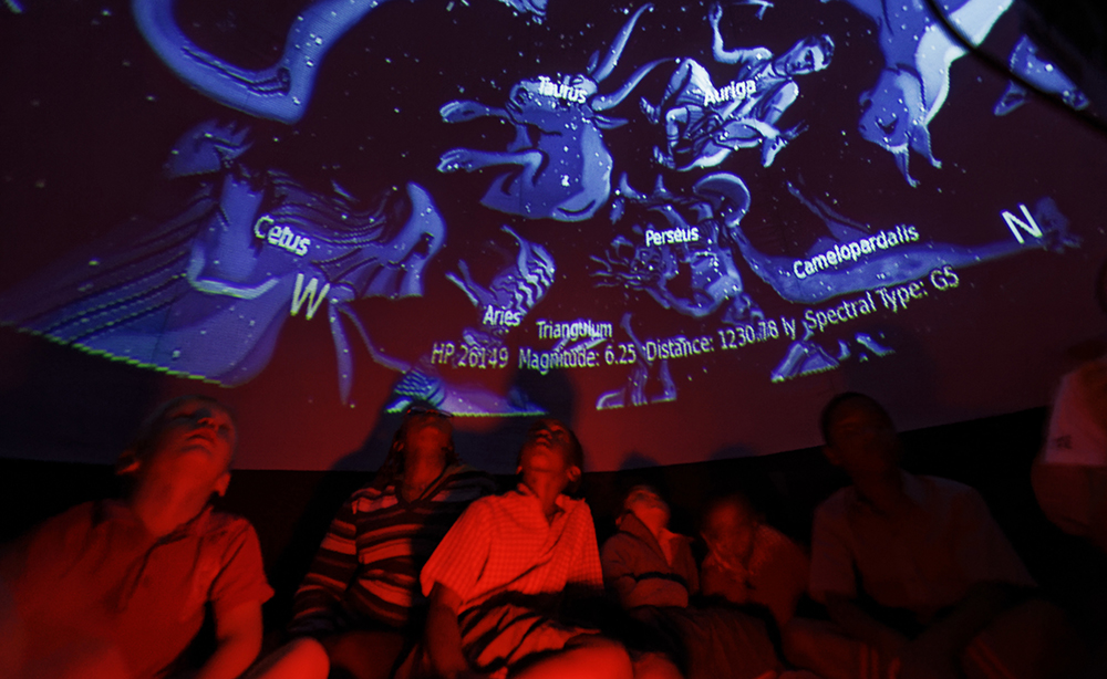 Students look up at a projected display inside an inflatable planetarium, during a visit by The Traveling Telescope to show students the science of astronomy, at St Andrew's School near Molo in Kenya's Rift Valley. (AP Photo/Ben Curtis)