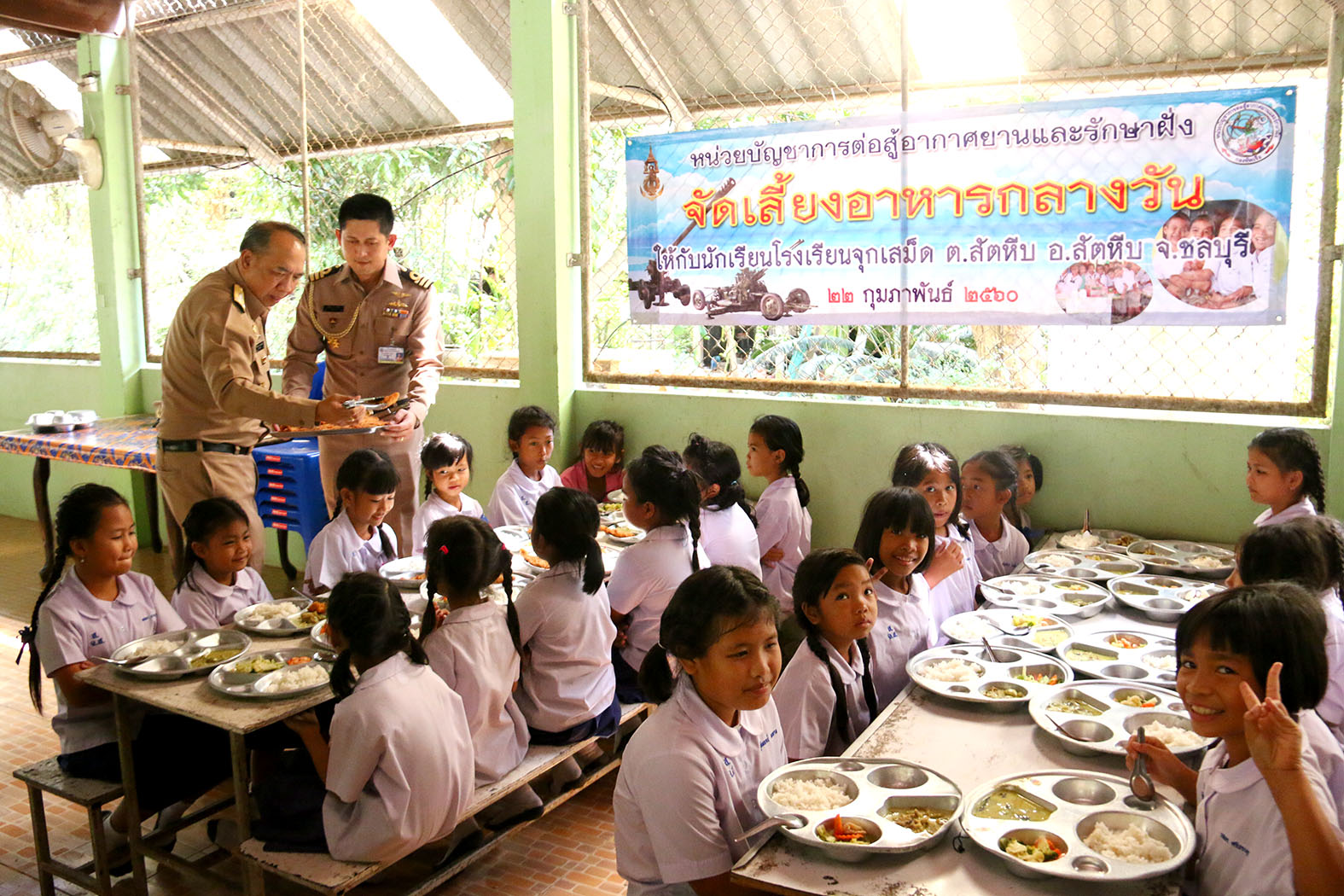 Rear Adm. Ekaraj Pornhomlampak, commander of Air and Coastal Defense Command, also helped feed the students at lunchtime.