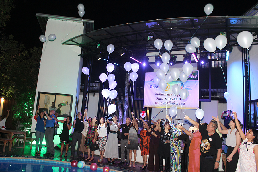 Rotarians and guests release white balloons as a symbol of peace for all mankind.