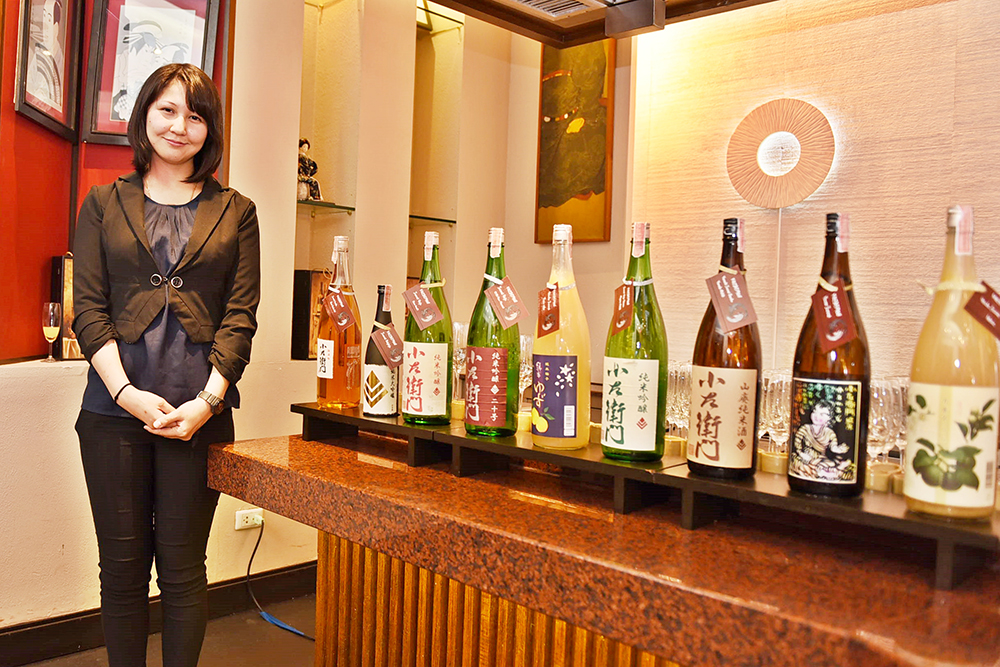 Naoko Saito from BB&B Co., Ltd., beside the nine premium sake’s from Kozaemon.