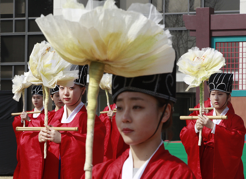 South Korean students wearing traditional Korean costumes perform during a graduation ceremony at Sungkyunkwan University in Seoul, South Korea. Most people born in rich countries will live longer by 2030, with women in South Korea projected to reach nearly 91, a new study published online Tuesday, Feb. 21, 2017 predicts. (AP Photo/Ahn Young-joon, File)