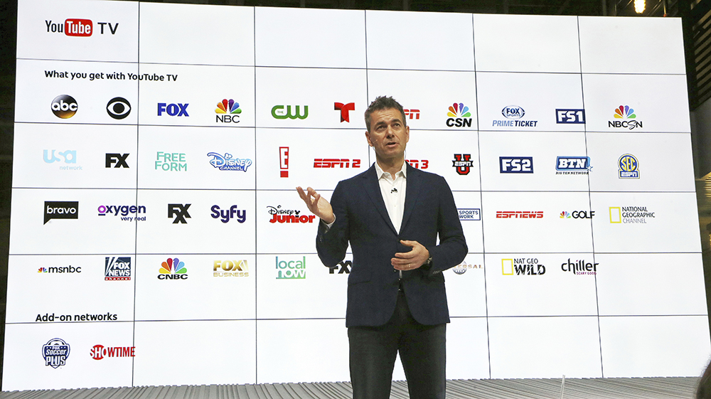 Chief Business Officer Robert Kuncl, with a graphic showing the many networks that will be carried, speaks during the introduction of YouTube TV at YouTube Space LA in Los Angeles. (AP Photo/Reed Saxon)