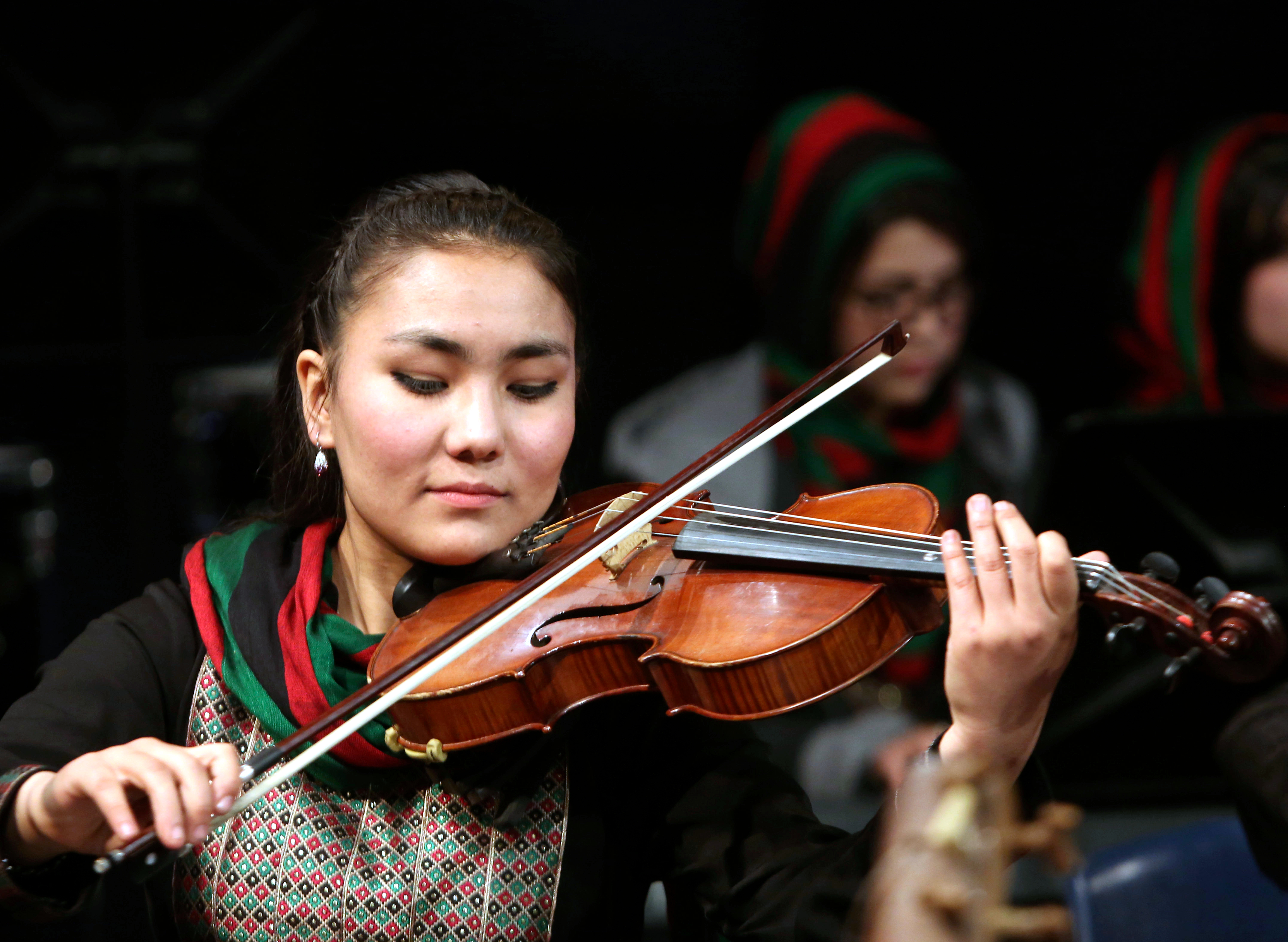In this Wednesday, Feb. 15, 2017 file photo, Zarifa Adiba, 18, an orchestra conductor in Afghanistan, plays during a concert in Kabul. (AP Photo/Rahmat Gul)