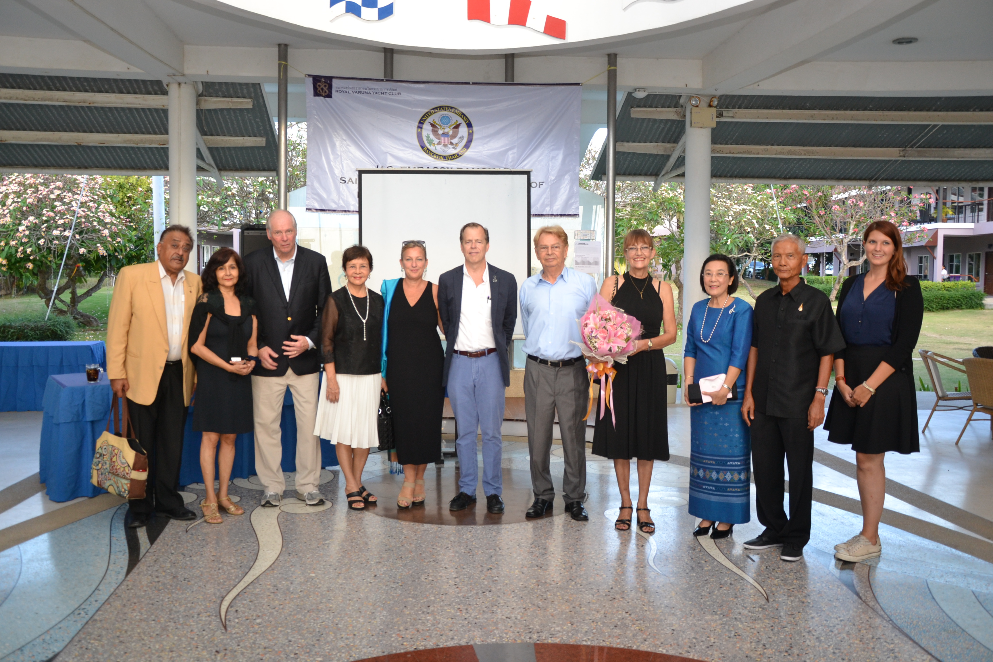 Ambassador Davies, Jackie and Gary Jobson pose for photos with community leaders.