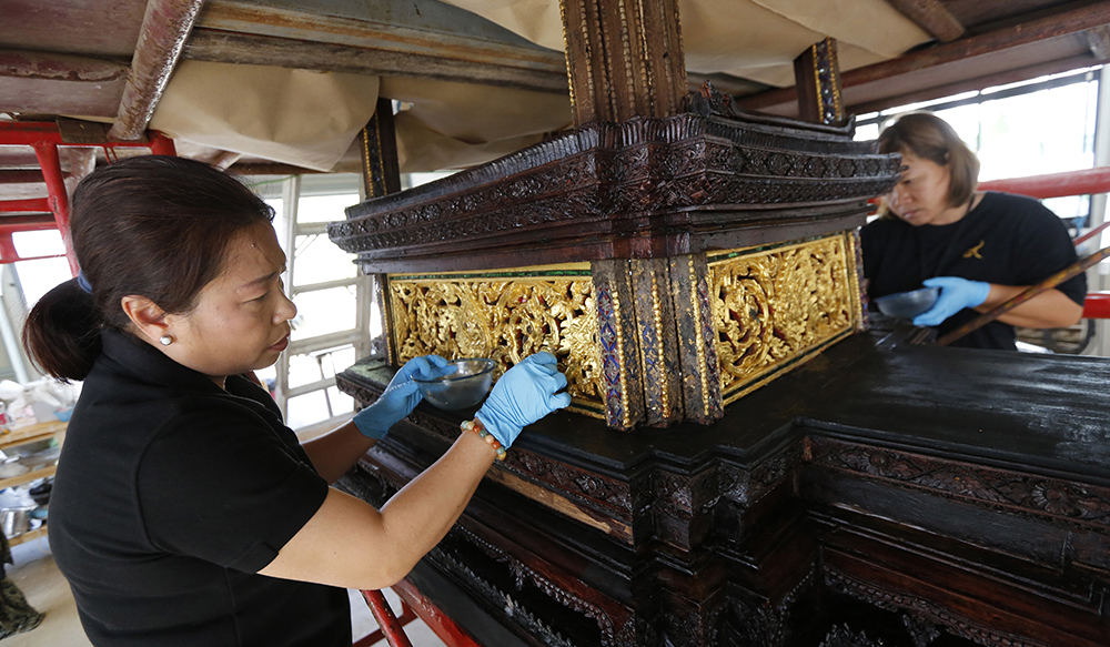 Artisans clean the royal funeral chariot to be used as part of the cremation for the late Thai King Bhumibol Adulyadej. (AP Photo/Sakchai Lalit)