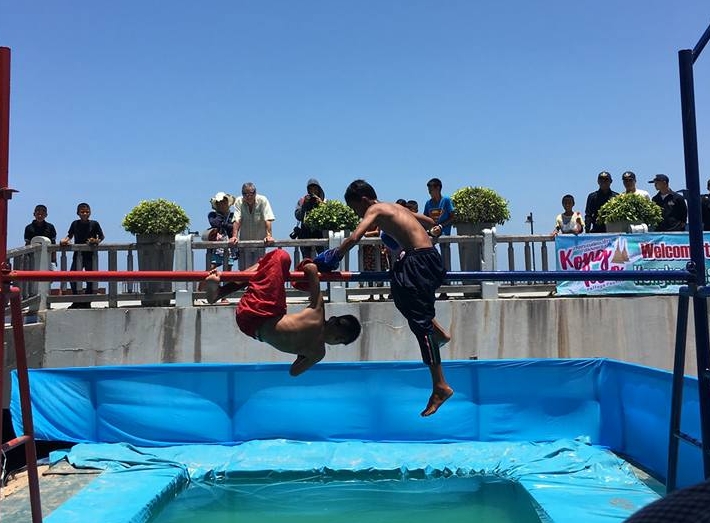 Youngsters battle in the traditional Muay Talay (Sea Boxing) competition – stay on the pole and you win, fall off and you lose.
