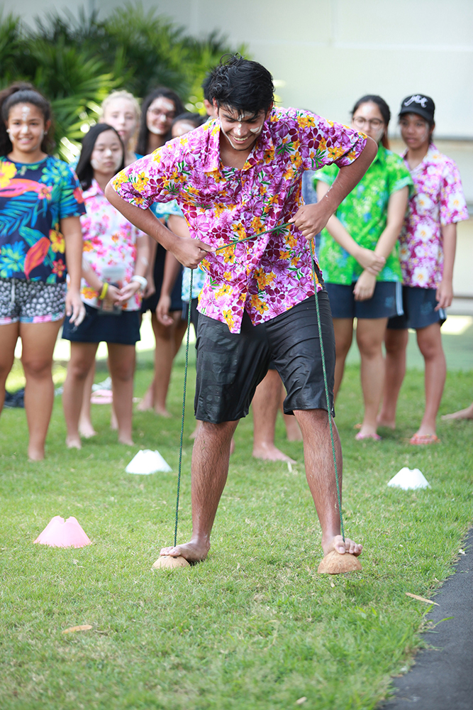 Walking on coconut shells - one of the traditional games played at GIS.
