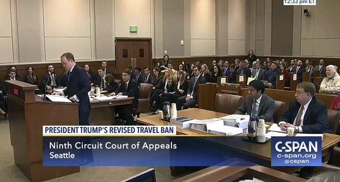 In this image made from a C-SPAN video, Acting Solicitor General Jeffrey Wall, standing at left, presents his arguments during a 9th Circuit Court of Appeals panel in Seattle, Monday, May 15, 2017. (CSPAN via AP, Pool)