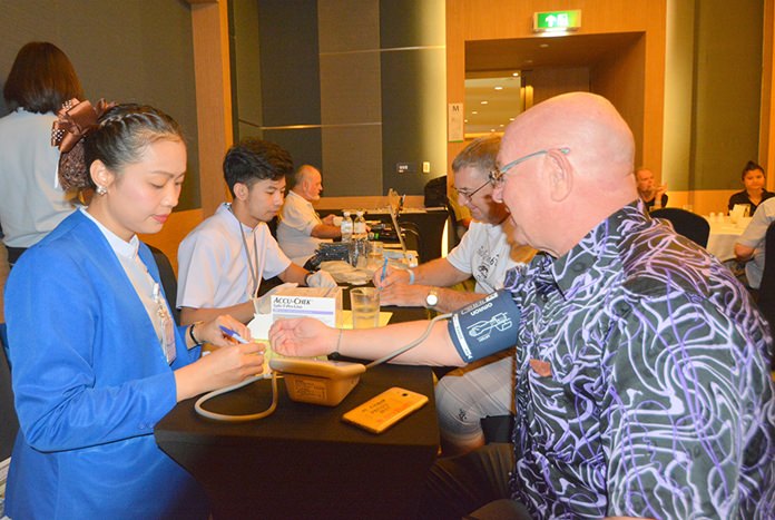 PCEC members and guests take the opportunity to receive free blood pressure and blood sugar checks from Bangkok Hospital Pattaya staff.