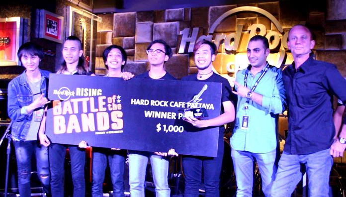 Members of Bangkok based rock band, Sickboy, pose with Hard Rock Pattaya officials on stage during the hotel’s international battle of the bands competition, May 20.