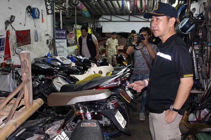 District Chief Naris Niramaiwong led Banglamung District authorities on a raid of a Pattaya-area motorcycle garage that specialized in illegal racing modifications.