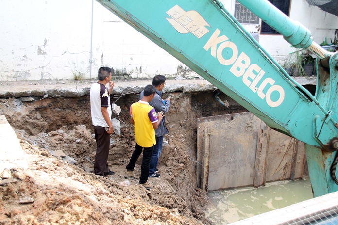 Prasert Laopradit said a drainage pipe-installation project is causing his and other homes to crack and sink.