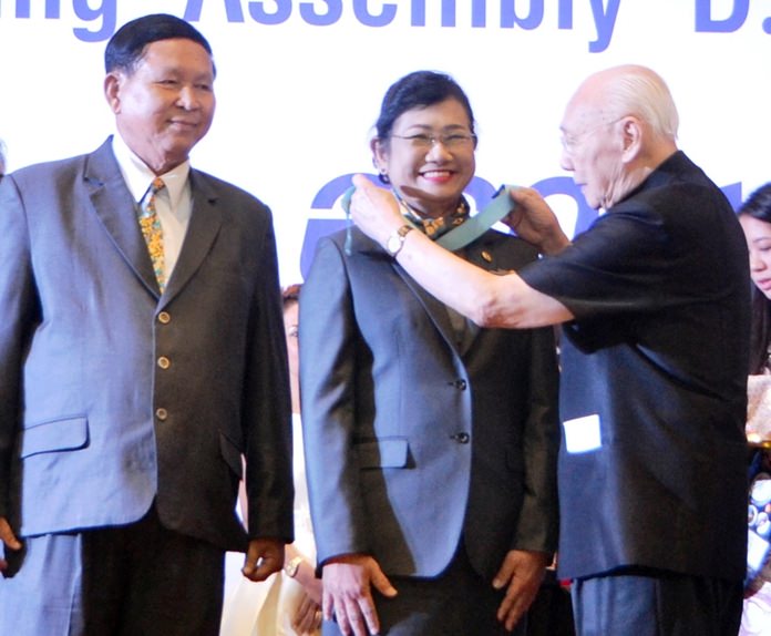 Past Rotary International President Bhichai Rattakul installs Onanong Siripornmanut as Governor of Rotary District 3340 as her caring husband Pradit looks on with pride.