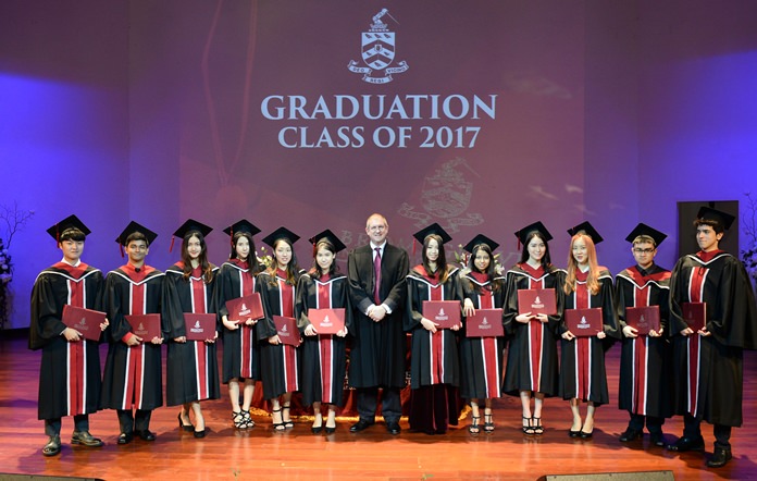 Head Master Dr. Daniel Moore poses with the Class of 2017 after presenting them with their diplomas.