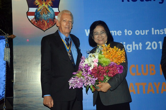 President Peter Schlegel presents DG Onanong with a bouquet of flowers.