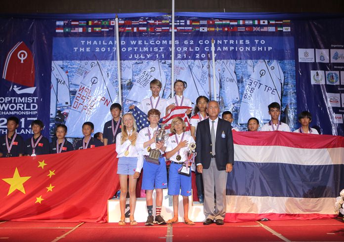 Team USA members (centre) pose on the podium with Admiral Kraisorn Chansuvanich, President of Yacht Racing Association of Thailand, and team members from Thailand (right) and China (left) during the trophy presentations for the Optimist World Championship 2017 at the Grand Heritage Hotel in Pattaya, Thursday, July 20.
