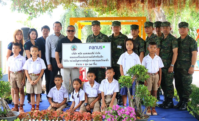 Rear Adm. Ekaraj Poromlampak accepts the donation of five sets of playground gear from Panas Assembly Co. representative Somsak Nonpho.