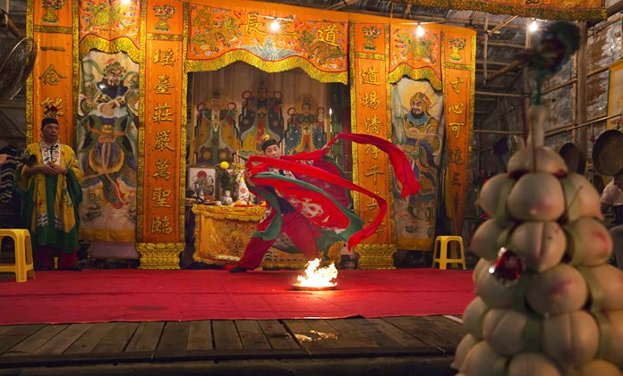 Taoists attend a service at a makeshift theater. (AP Photo/Kin Cheung)