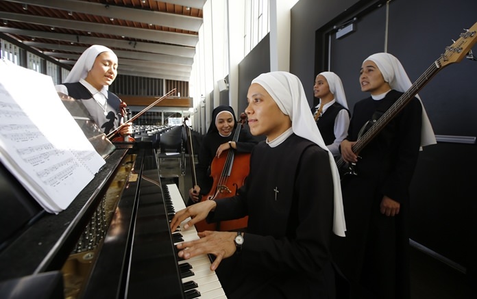 Members of “Siervas,” a Peruvian-based rock ‘n’ roll band comprised entirely of Catholic nuns rehearse a day ahead of their performance at the Christ Cathedral campus in Garden Grove, Calif. (AP Photo/Damian Dovarganes)